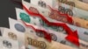 GENERIC – Red arrows pointing down on the background of russian money